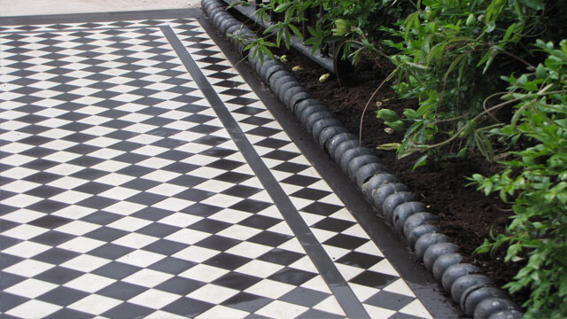Victorian black and white path tiles with rope-top edging alongside.