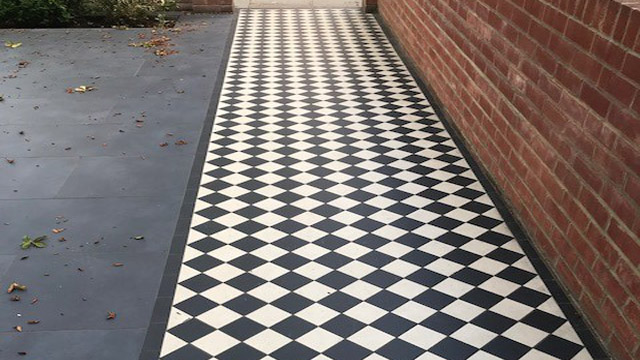 Long garden path with Victorian style black and white tiles.
