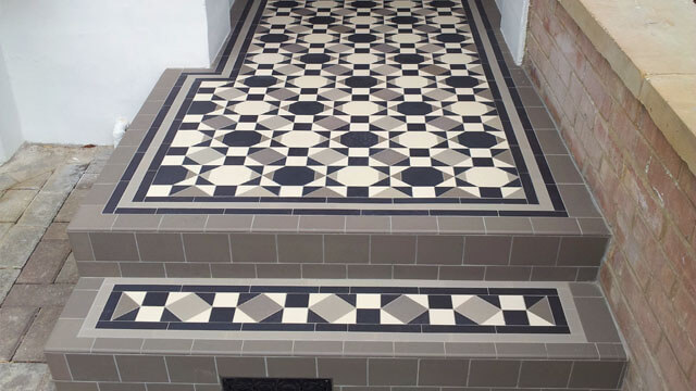Contemporary use of geometric Victorian tiles on entryway steps.