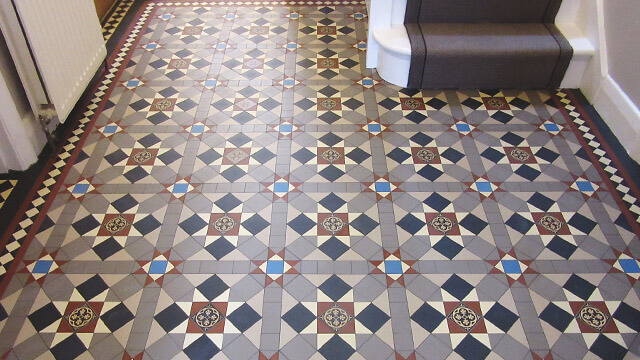 Popular Victorian hall floor tile pattern in grey colour tones, with red and blue highlights.