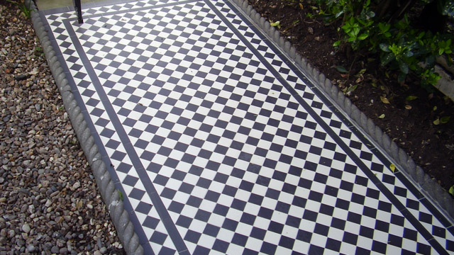 Traditional black and white Victorian path tiles, with rope top edging to sides.