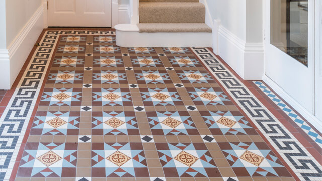 Highly decorative geometric tile design featuring a Greek key border motif. Bespoke Victorian Floor Tile design to match the period original in adjoining room.