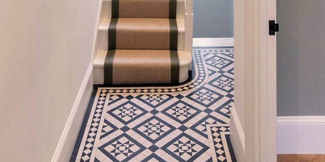 Black and White Georgian style mosaic pattern in hallway leading to staircase with runner.