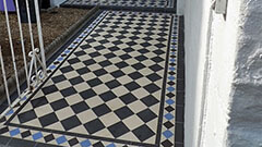 Edwardian Black and White Path Tiles - The blue tiles in the border design accent door colour.