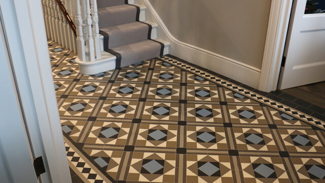 Hall - Contemporary geometric floor tiles. A unique ceramic floor design in warm greys, cool blues, black and white tiles, commissioned for a house renovation project.