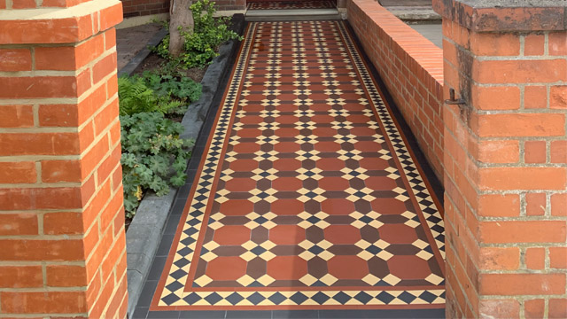 A traditional Edwardian exterior tiled path composed of octagon and hexagon shapes in red, brown, black and buff.