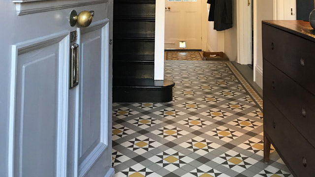 Mosaic hallway floor tile design in grey and yellow.