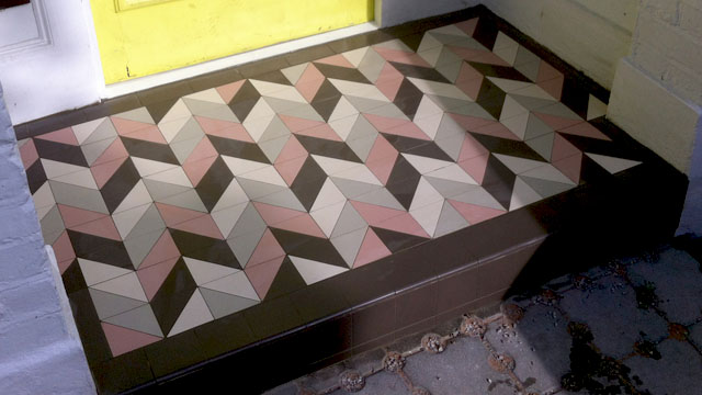 Black, White, Pink and Grey triangular ceramic tiles on porch step floor