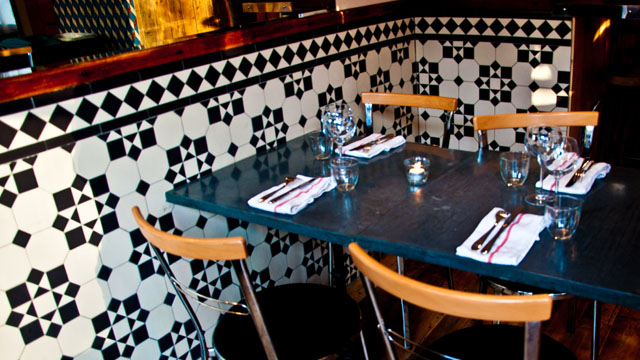 Resturant bar front fitted with black and white geometric Victorian tile pattern.