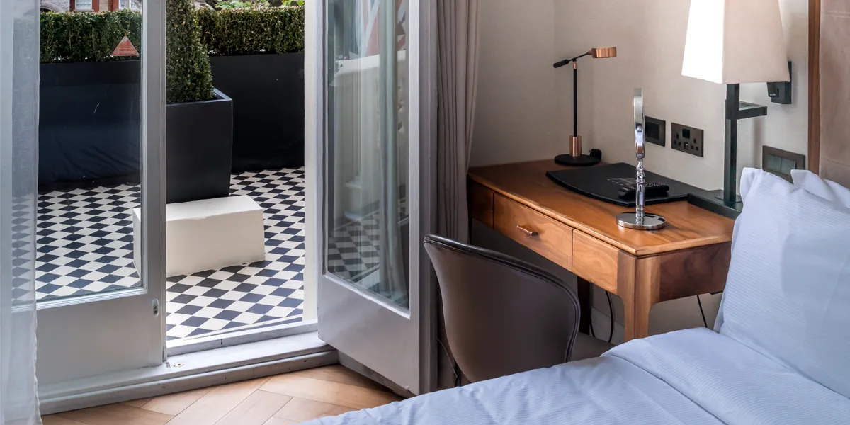 Black and white chequerboard tiles on hotel balcony