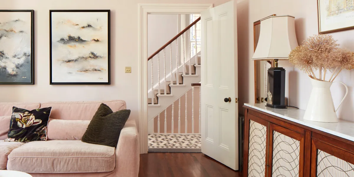 Black, white and grey Victorian hall floor tiles, alongside staircase, viewed through livingroom door.
