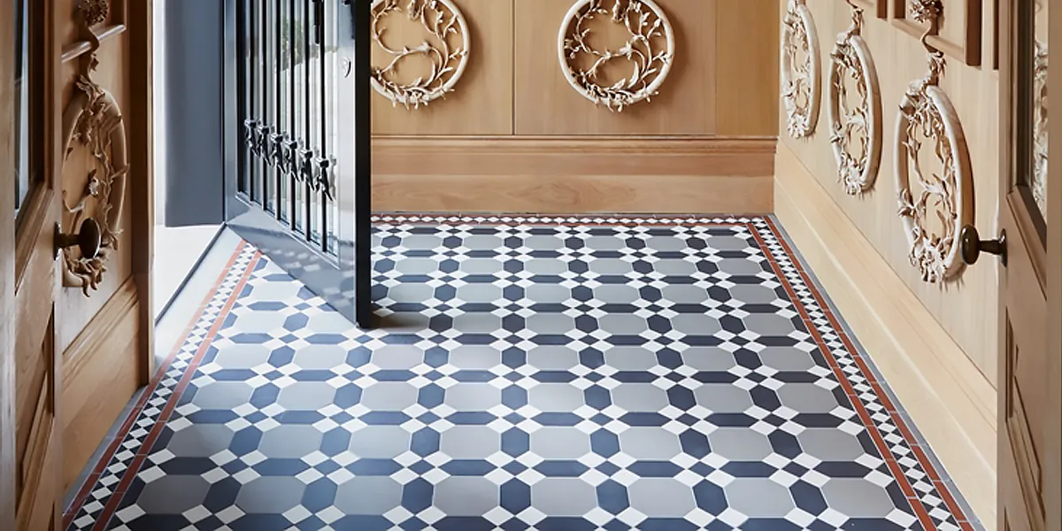 Grey, black, white and red octagon and long hexagon, a traditional tile design in vestibule with wooden wall panels.