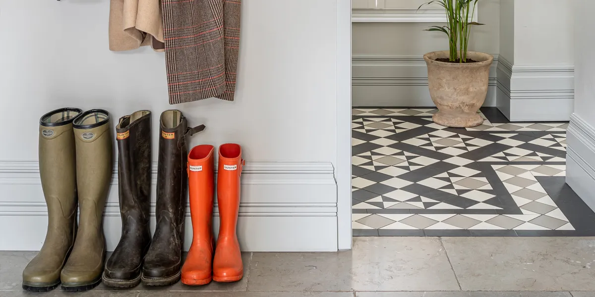 Traditional Victorian tile pattern in larger format and modern colour scheme, alongside 3 sets of wellington boots.