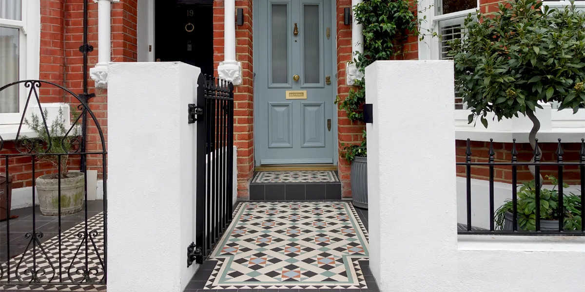 Black and white mosaic path tiles with red, blue and green highlights