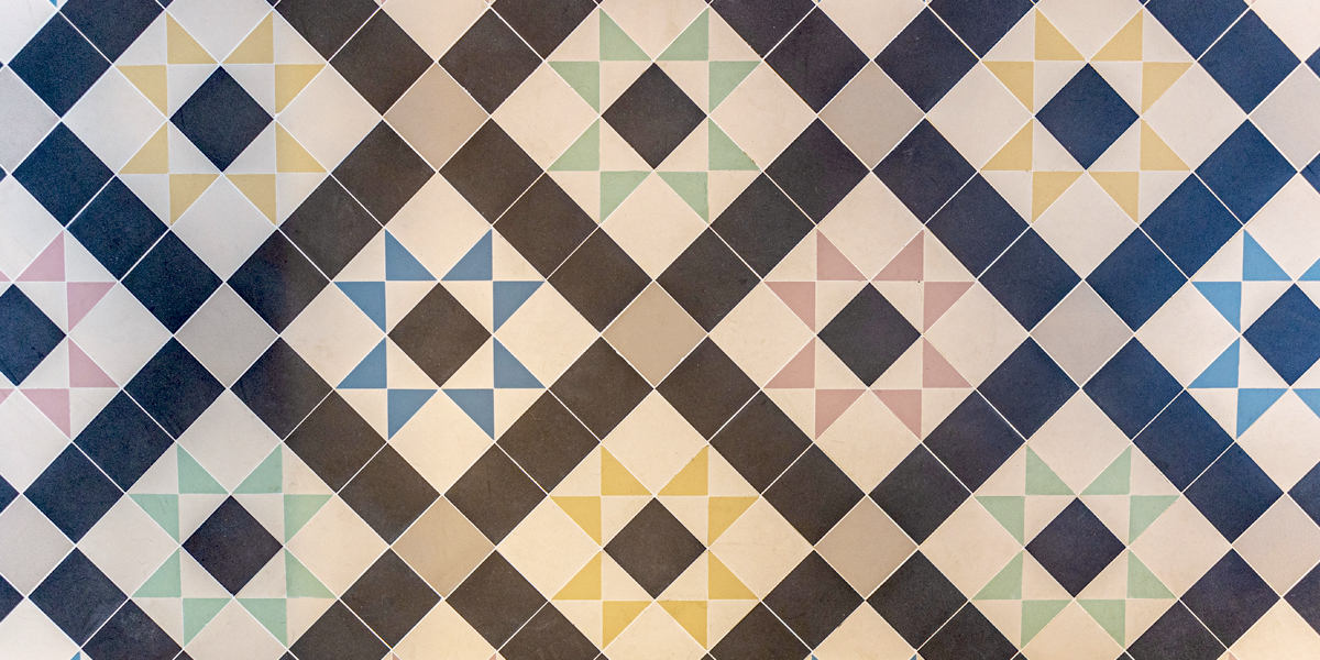 Warm toned Victorian mosaic tiles in entrance hallway