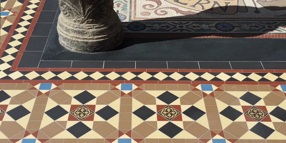 A traditional Victorian mosaic tile pattern around the outside of a pub entrance.