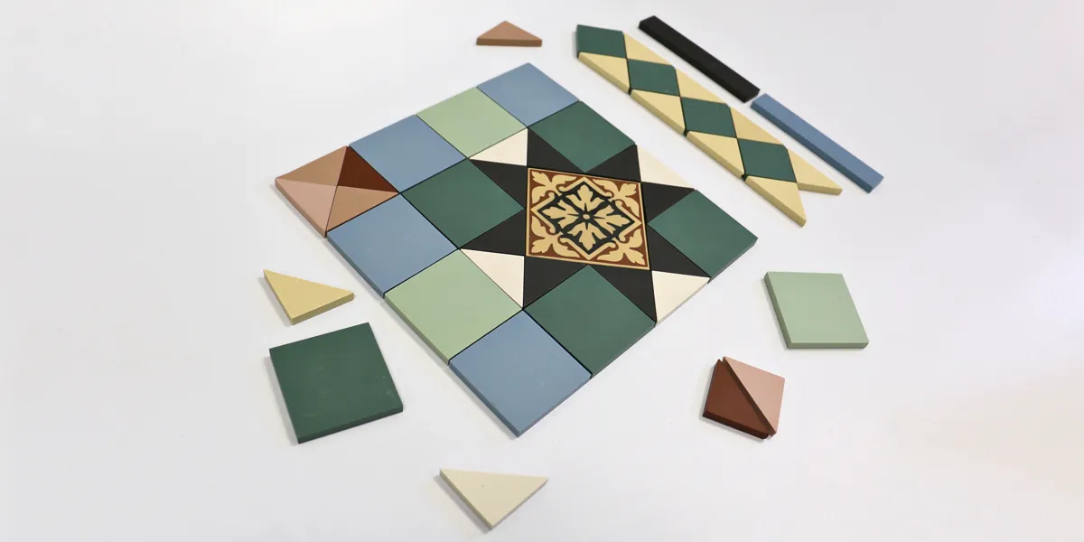 A selection of multi-coloured ceramic tiles laid out in a traditional pattern.