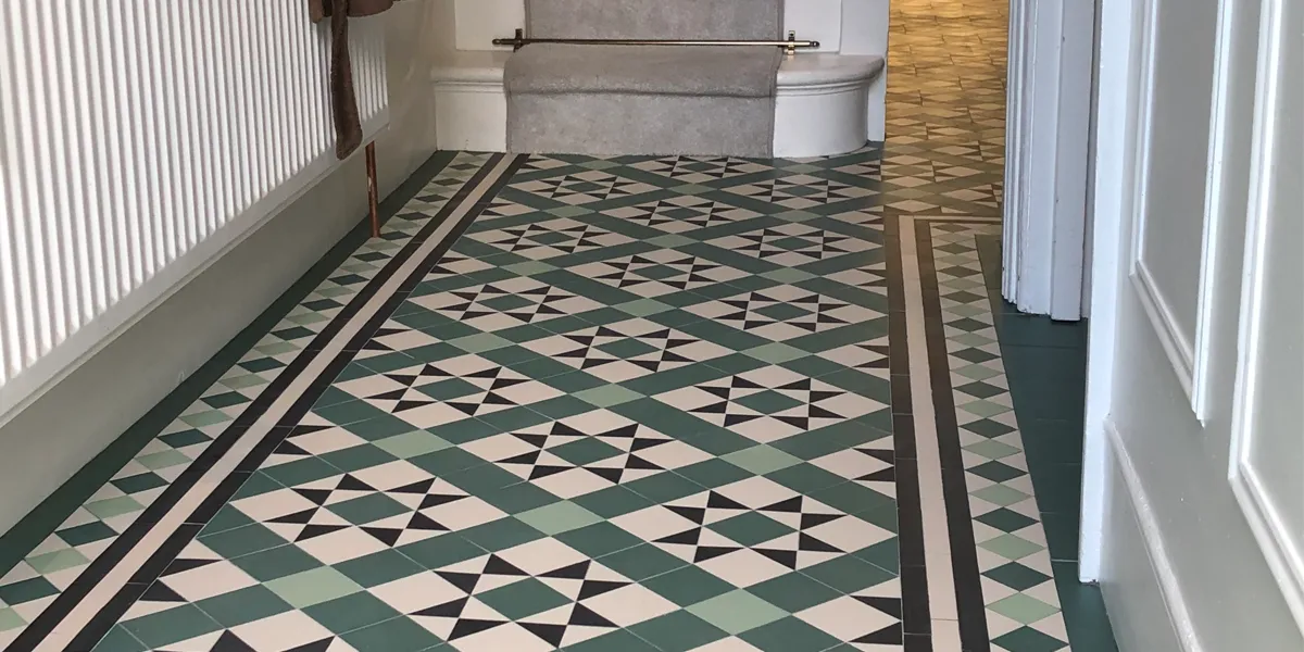 Period star and box motif geometric hallway floor design in green tones.