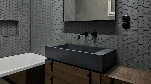 Contemporary bathroom with grey 50mm hexagon tiles on walls.