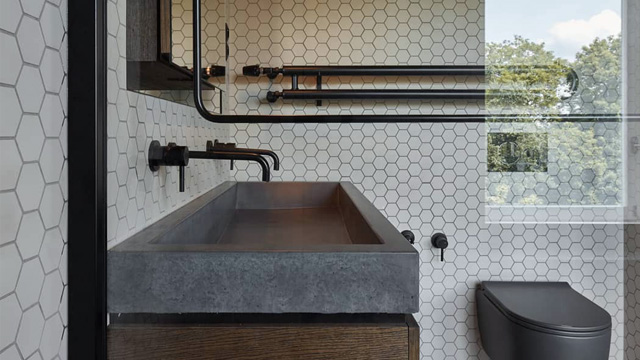 Modern bathroom with white 50mm hexagon tiles on walls.