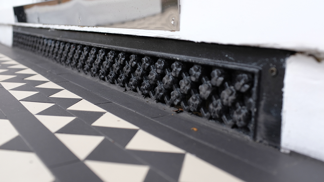 Victorian Daisy Grate grille under York stone step.