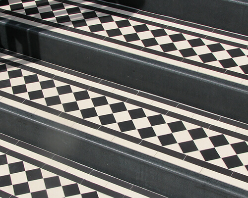 Granite step risers with checkerboard step treads.