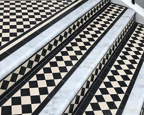 Marble bullnose step edges with classic black and white chequerboard treads