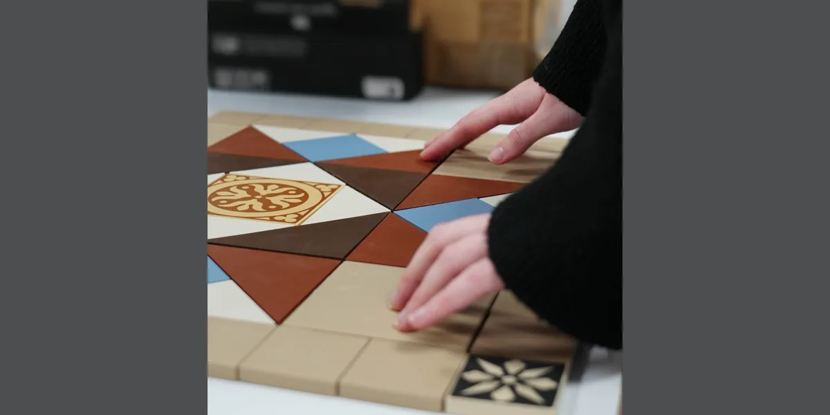 Colourful mosaic tiles being assembled in to a pattern
