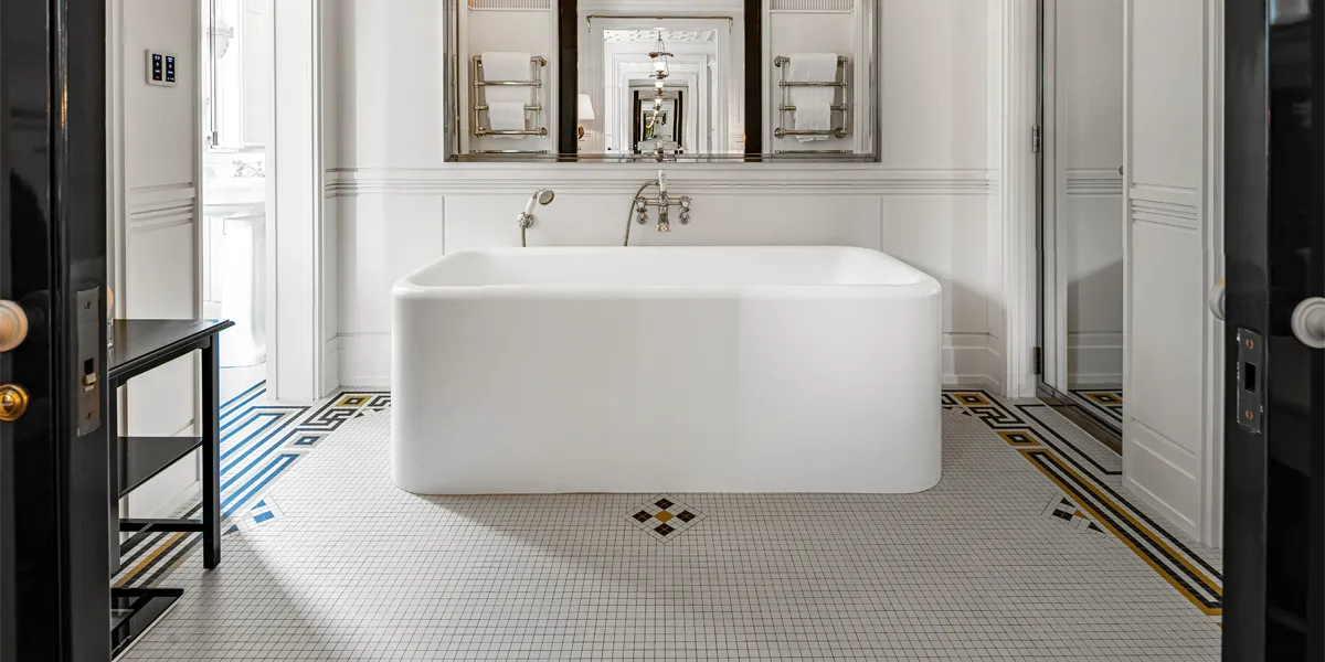 White 20mm mosaic with a border of yellow and black in an Art-Deco style, in luxury hotel bathroom