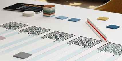 Tile design consultancy. Sample tiles, ruler and design options on office desk.