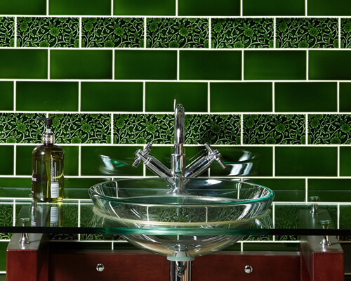 Victorian dark (racing) green wall tiles with modern utility room basin.