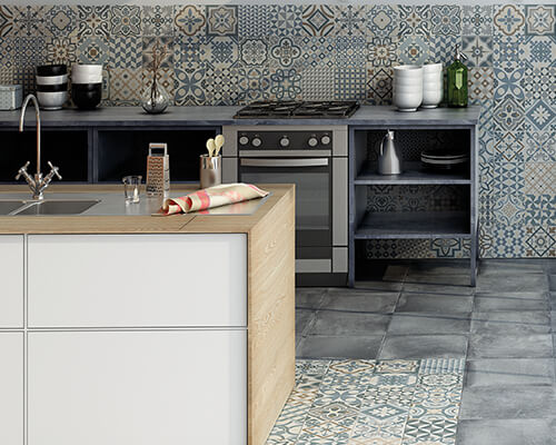 Modern kitchen leading to outdoor balcony featuring patchwork printed encaustic style tiles.