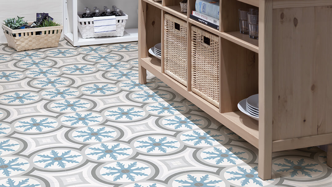 Printed large format porcelain tiles on pantry floor in tones of blue and grey.