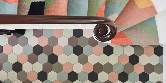 150mm hexagon tiles in a random arrangement of colours alongside a staircase with bold coloured stair runner.