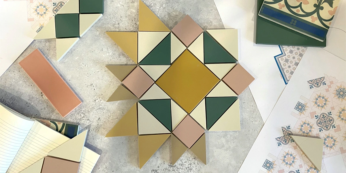 Selection of colourful tiles and diagrams laid out on desk