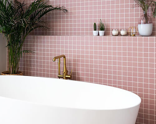 Mesh backed Pink 50mm square tiles on bathroom wall and floor.
