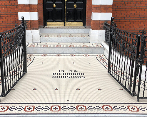 Grand entrance steps with border motif and text composed of 20mm square tiles.
