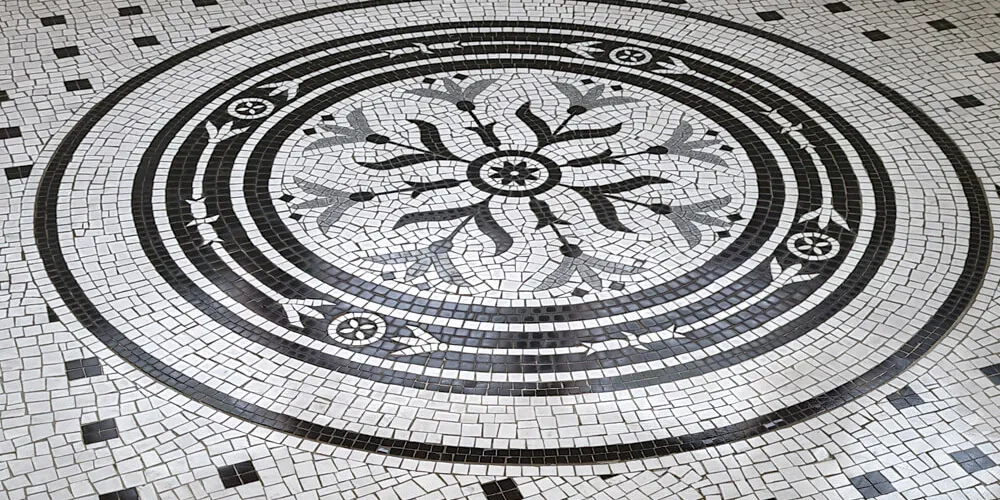 Art Nouveau style marble mosaic motif in white, black and grey tesserae.