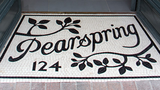 Pearspring shop entrance. Hand cut and hand-assembled mosaic in white and black tiles.