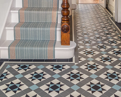 Reproduction Victorian hall flooring in a modern colour palette of black, white, grey and blue - the Stevenson design. New stair runner complements the tile colours.