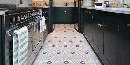 25mm hexagon tiles with floral motif in dark green, on the floor of a modern kitchen