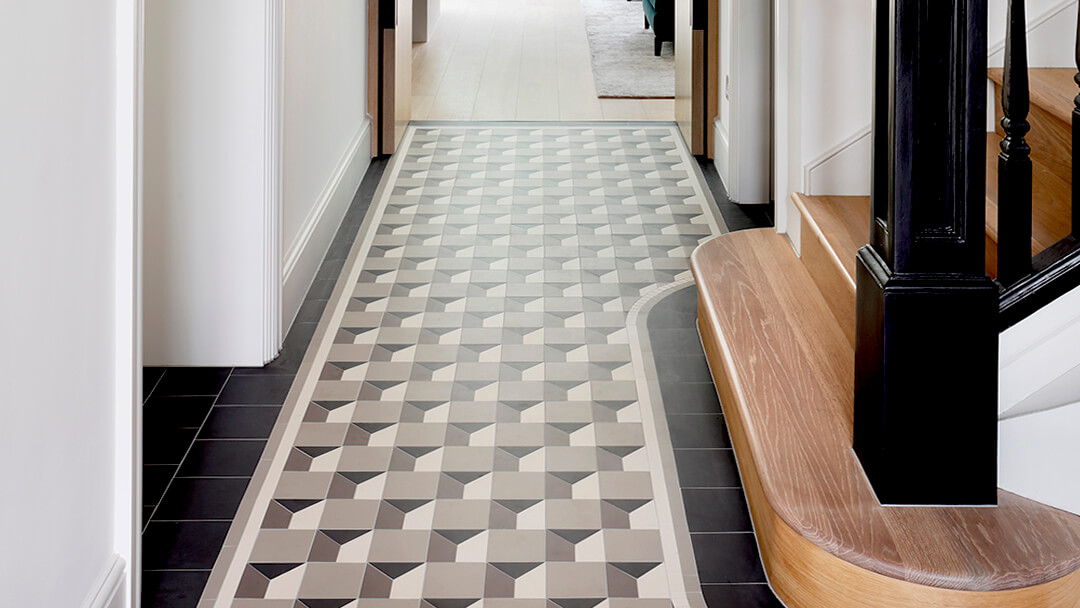 Contemporary geometric hall foor tile pattern combining waterjet cut trapeziums with standard square and triangle shapes